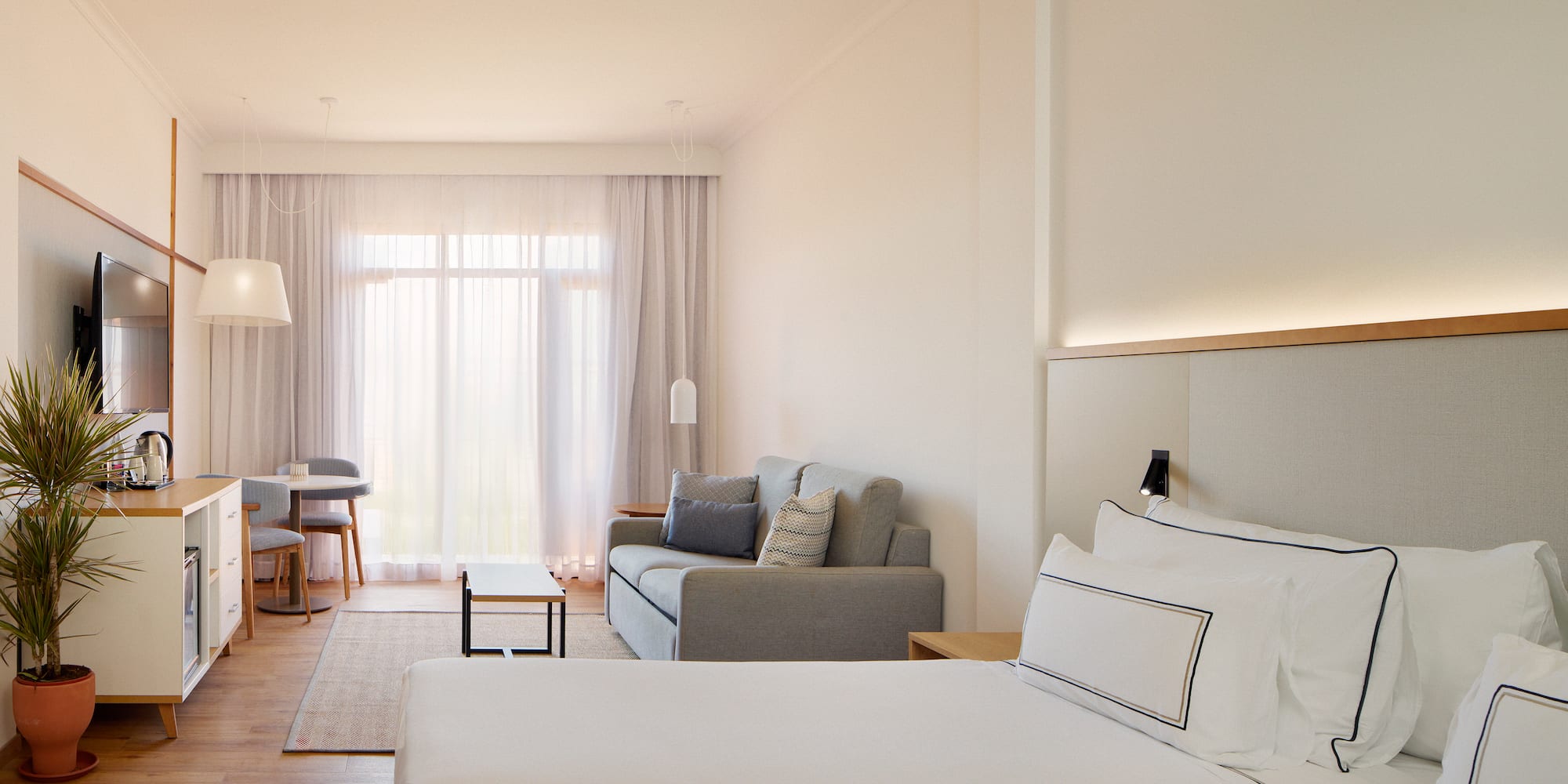 a room with two beds and a couch