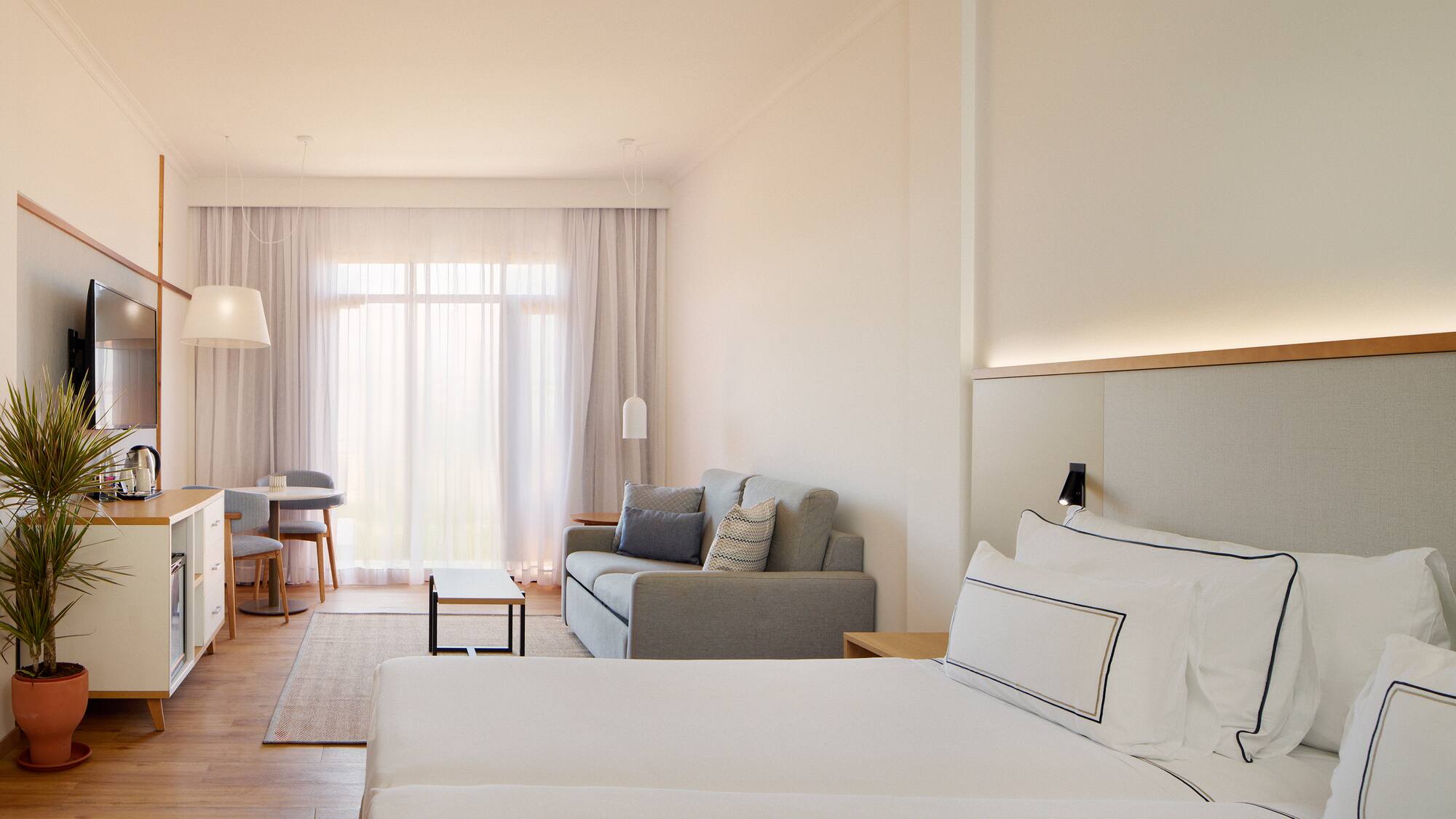 a room with two beds and a couch