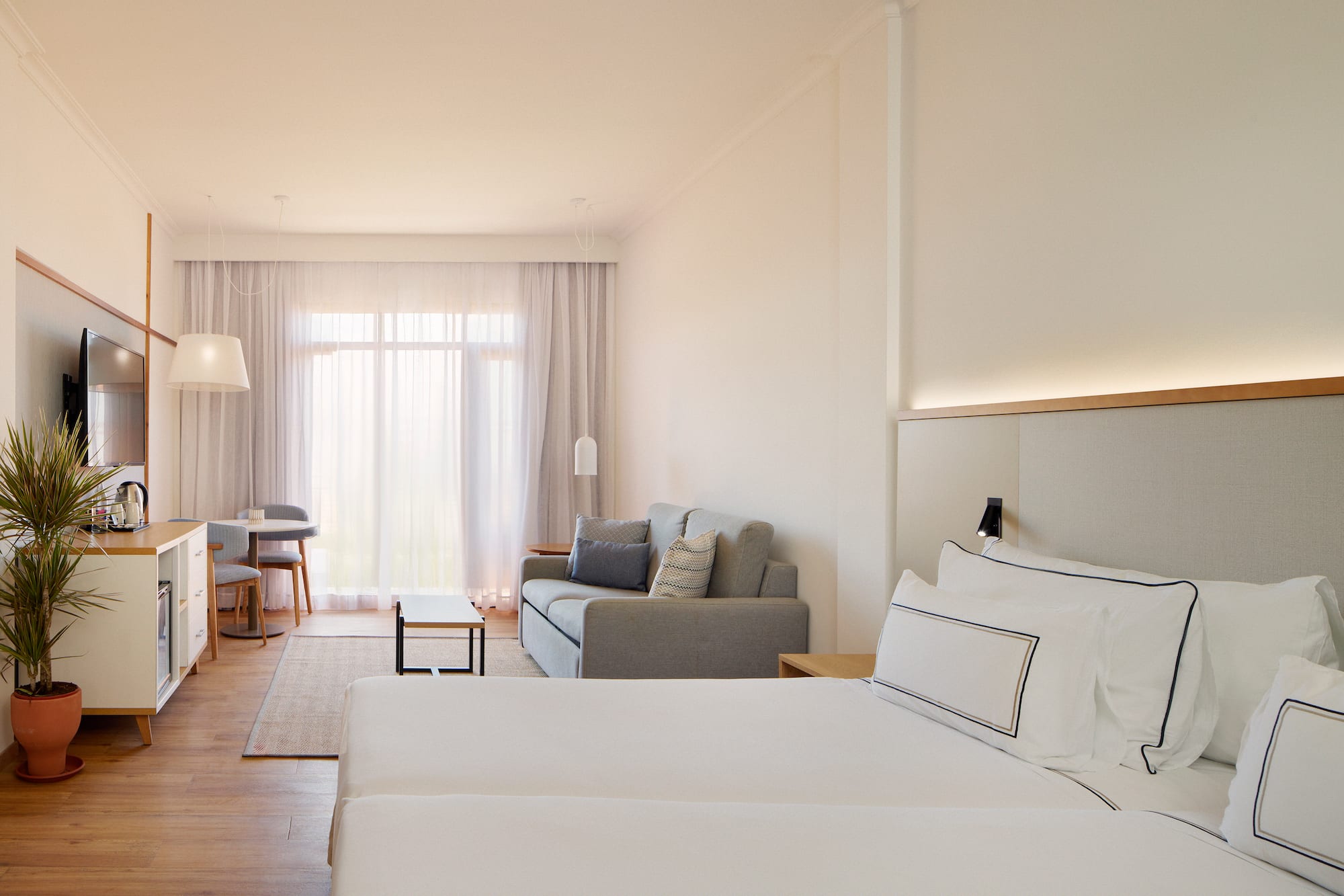 a room with two beds and a couch