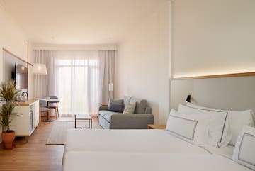 a room with two beds and a couch