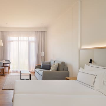 a room with two beds and a couch