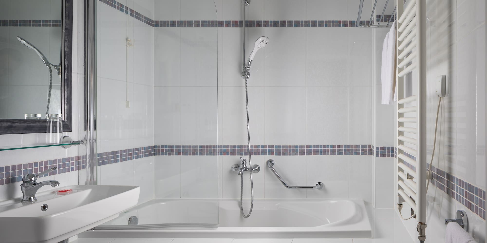 a bathroom with a shower and tub