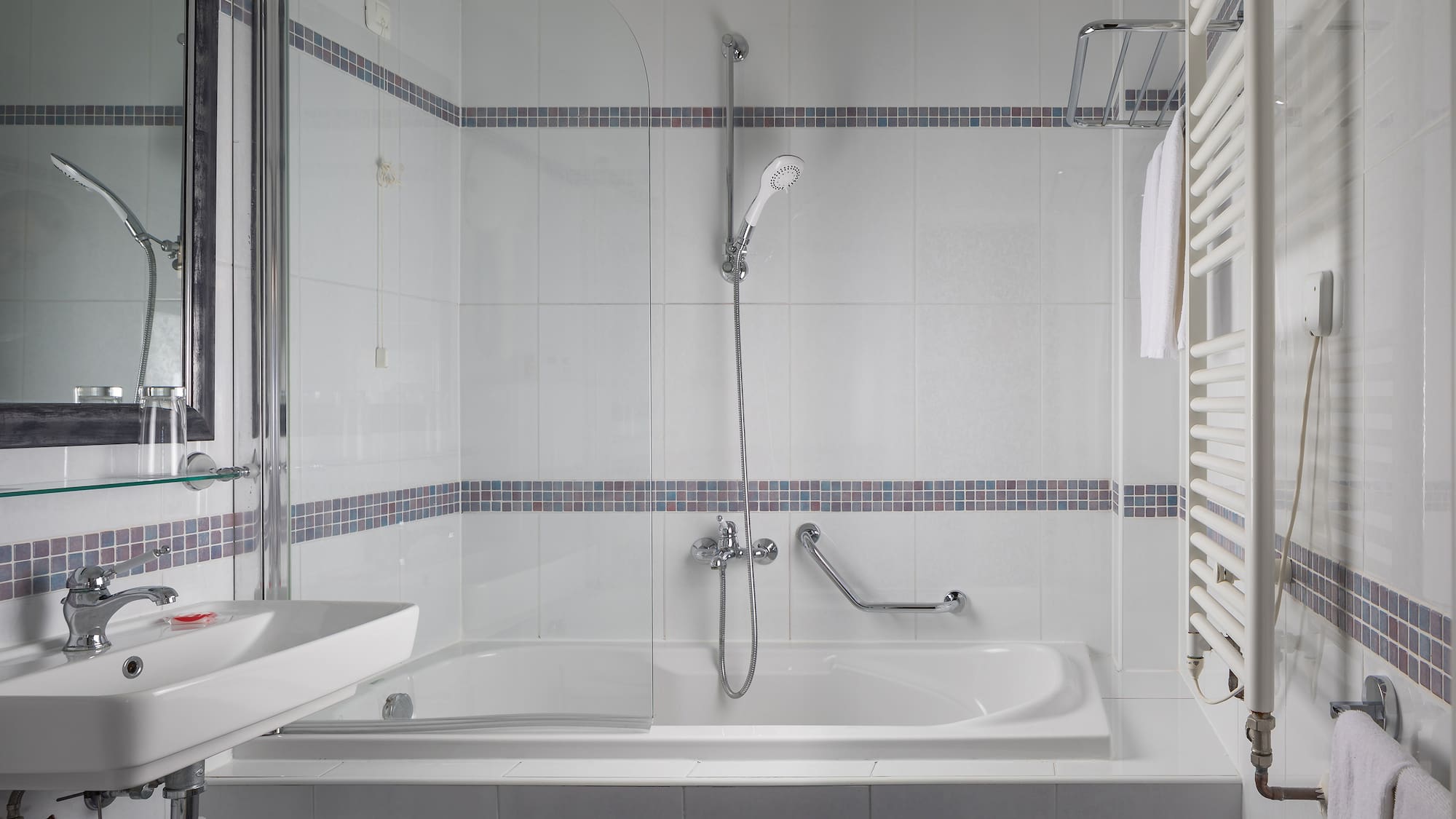 a bathroom with a shower and tub
