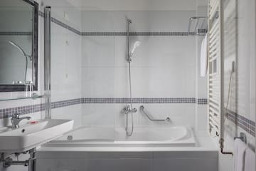 a bathroom with a shower and tub