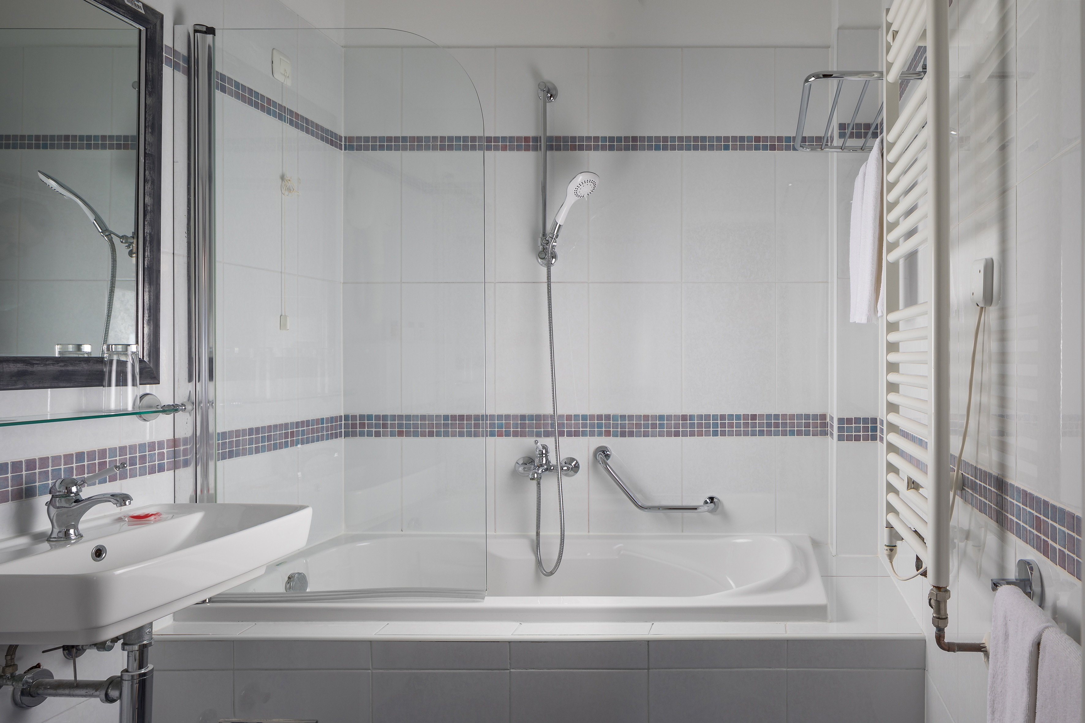 a bathroom with a shower and tub