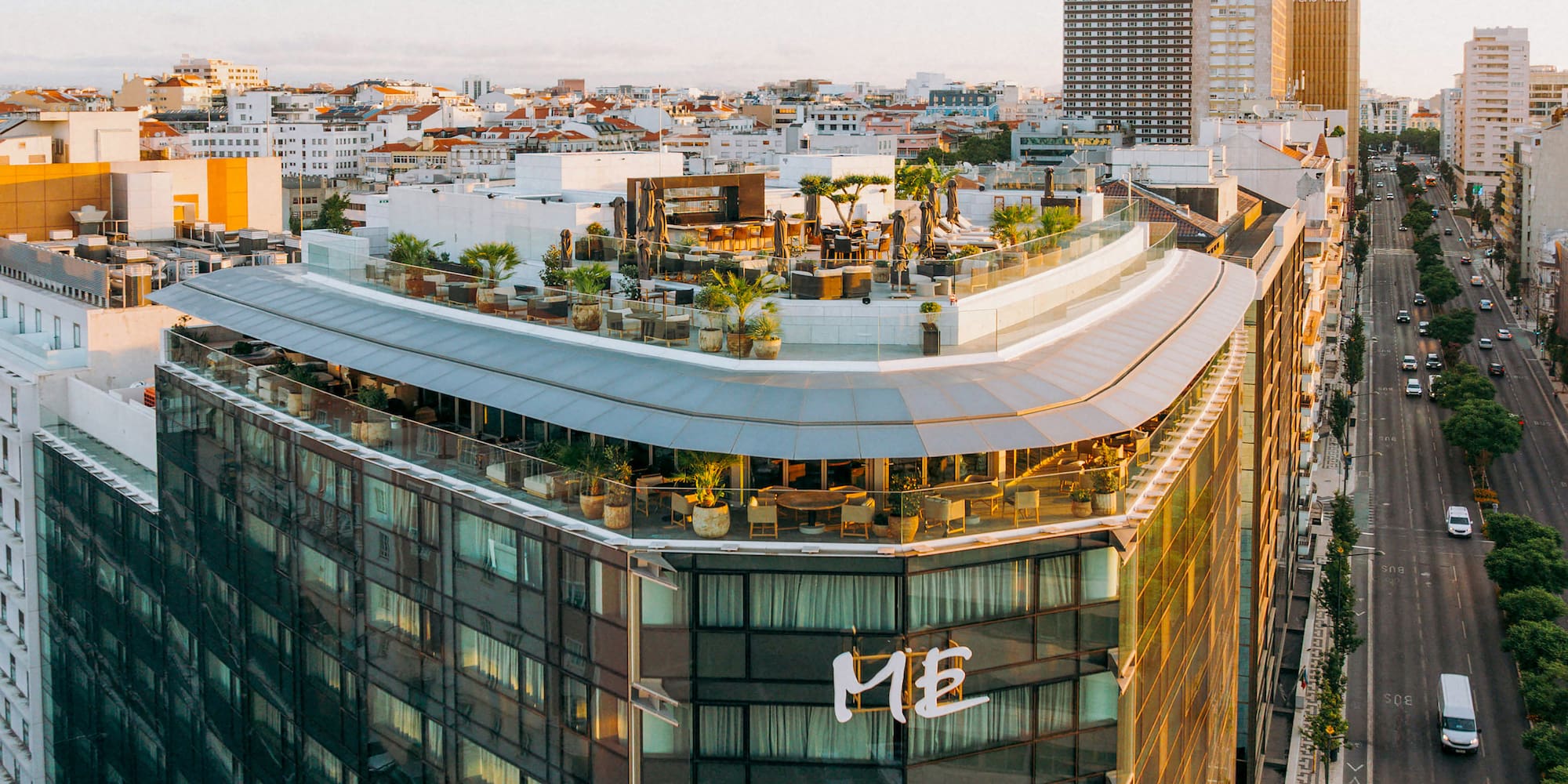 a rooftop of a building with a rooftop bar and a city