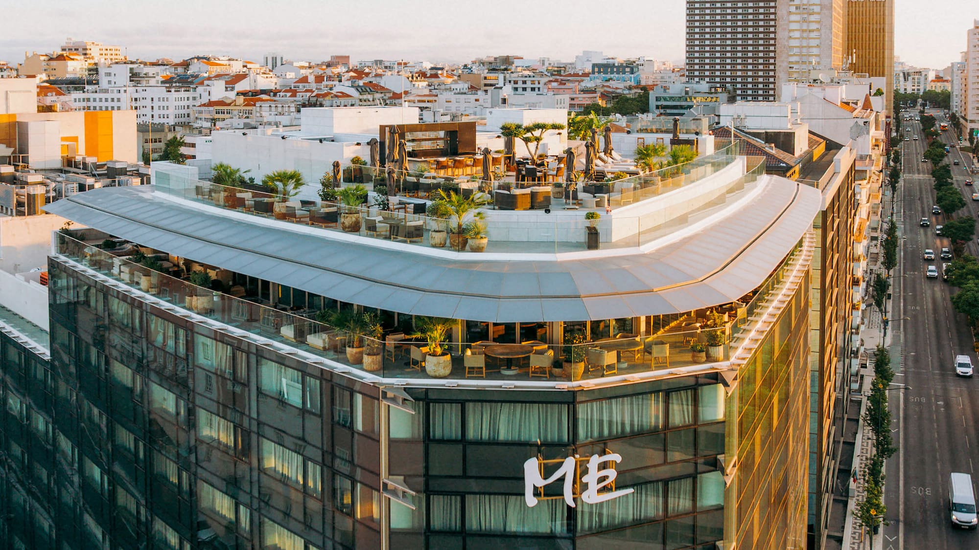 a rooftop of a building with a rooftop bar and a city