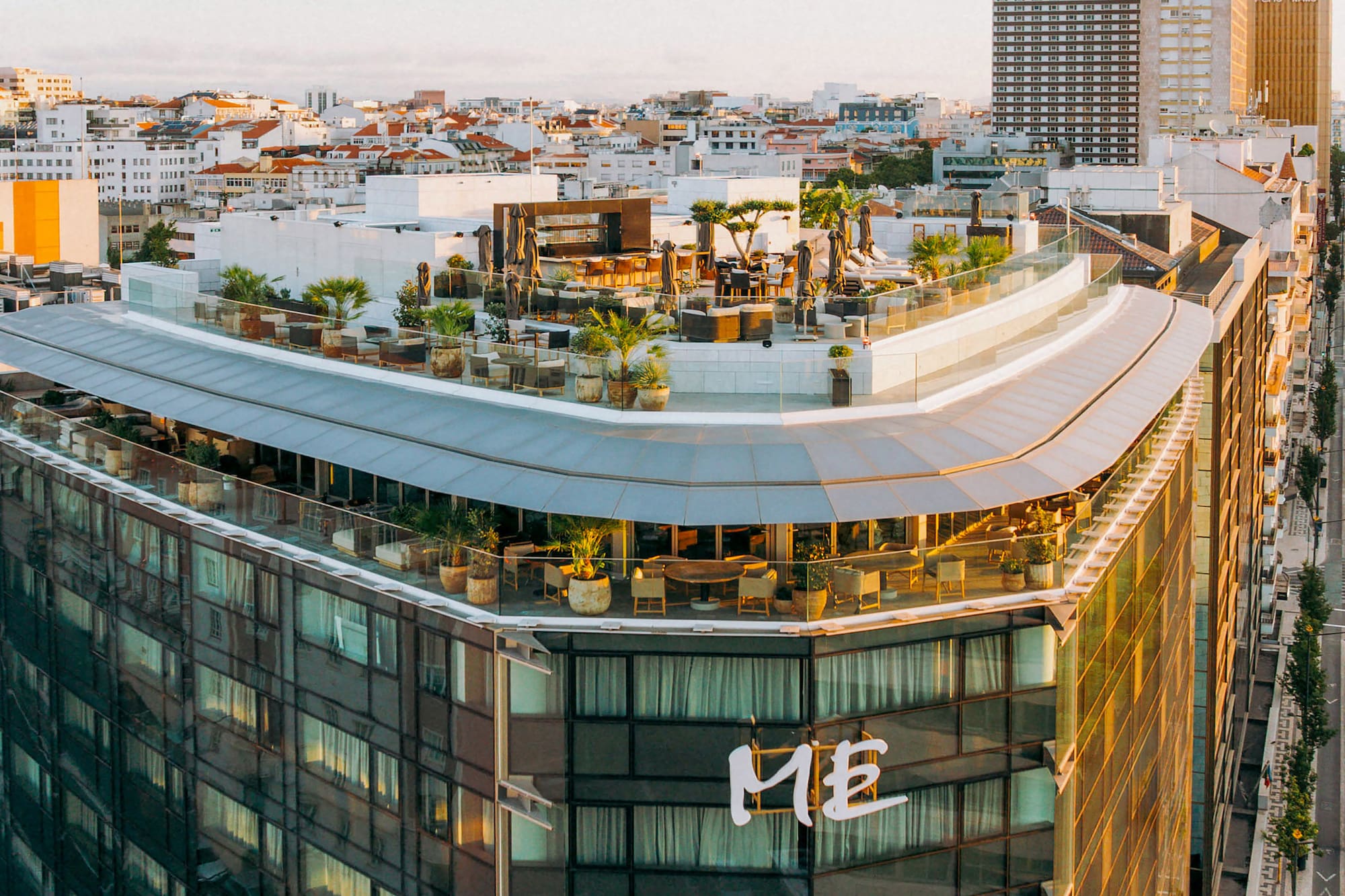 a rooftop of a building with a rooftop bar and a city