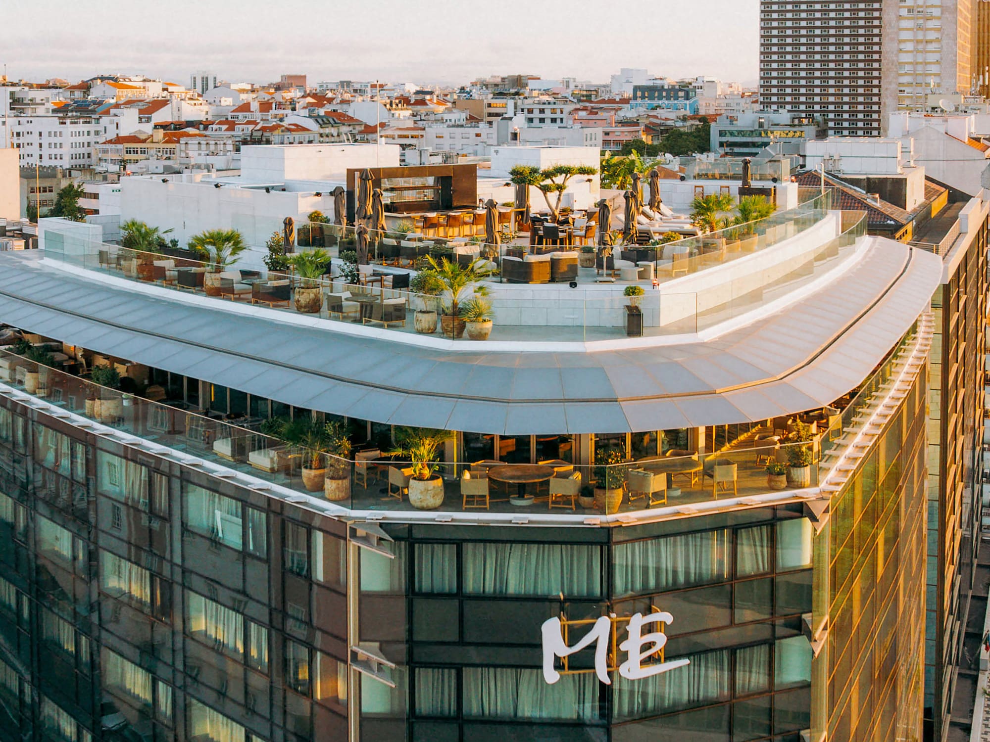 a rooftop of a building with a rooftop bar and a city