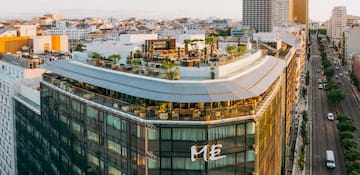 a rooftop of a building with a rooftop bar and a city