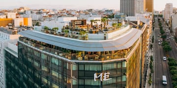 a rooftop of a building with a rooftop bar and a city