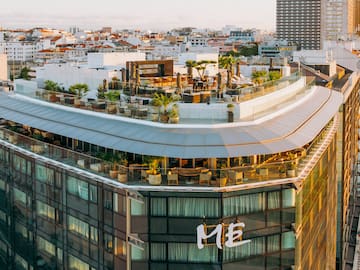 a rooftop of a building with a rooftop bar and a city