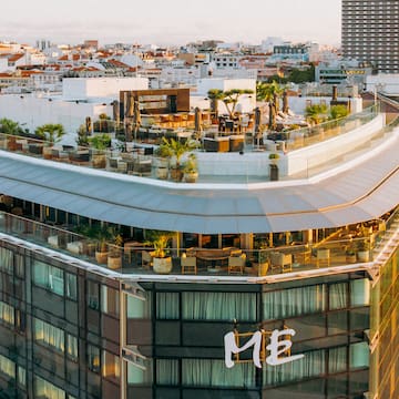a rooftop of a building with a rooftop bar and a city
