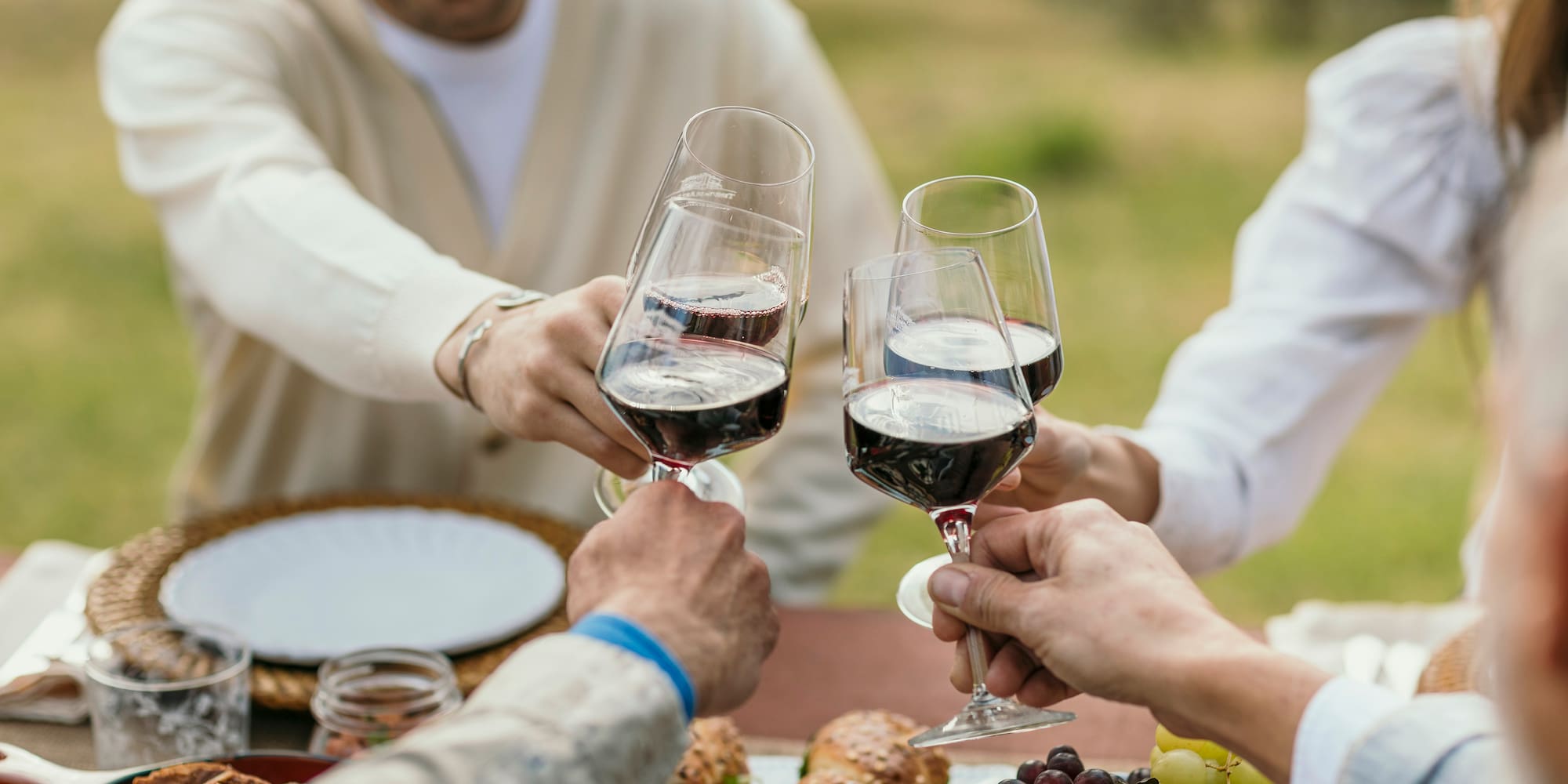 a group of people clinking wine glasses