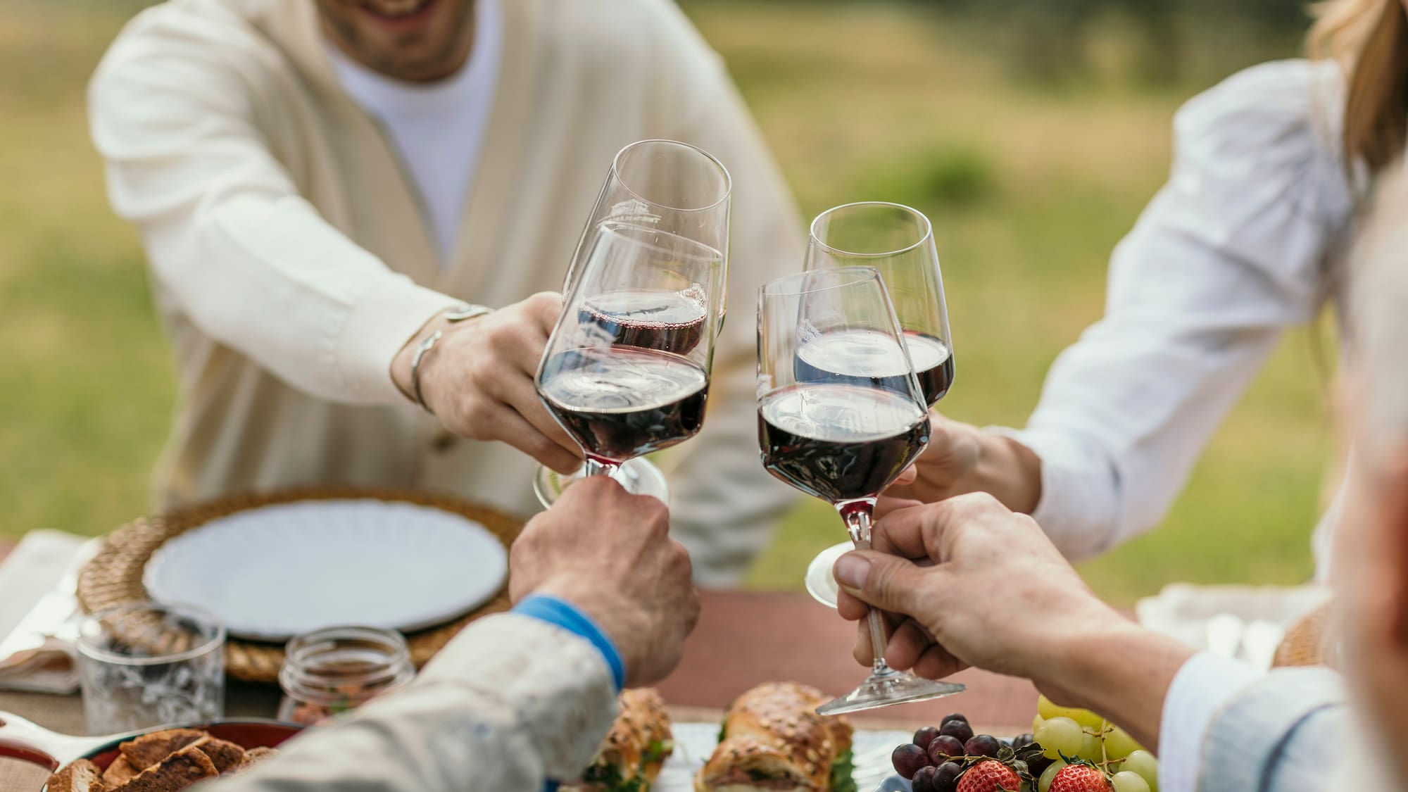 a group of people clinking wine glasses