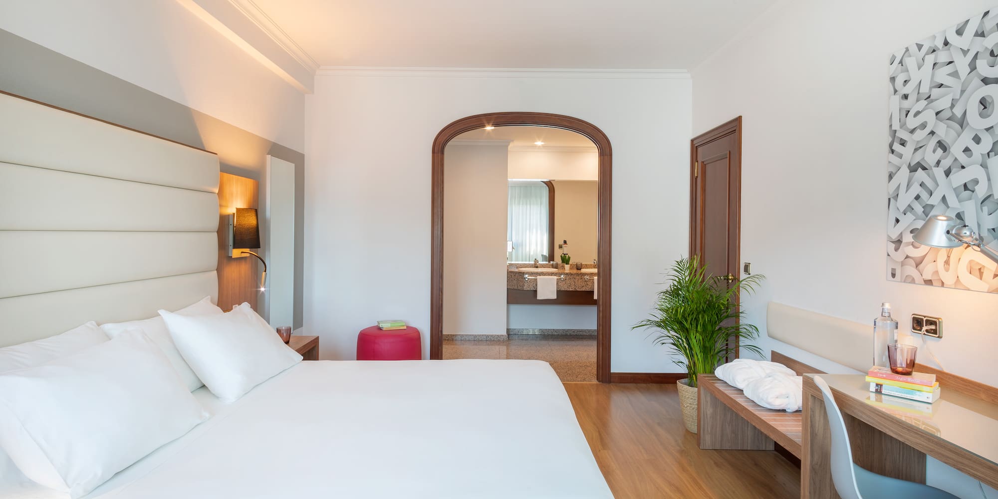 a bedroom with a bed and a bench