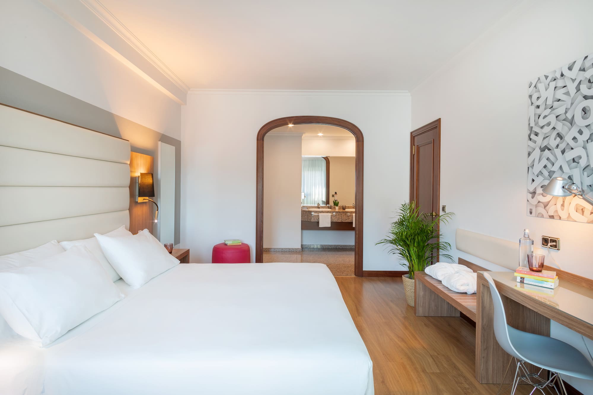 a bedroom with a bed and a bench