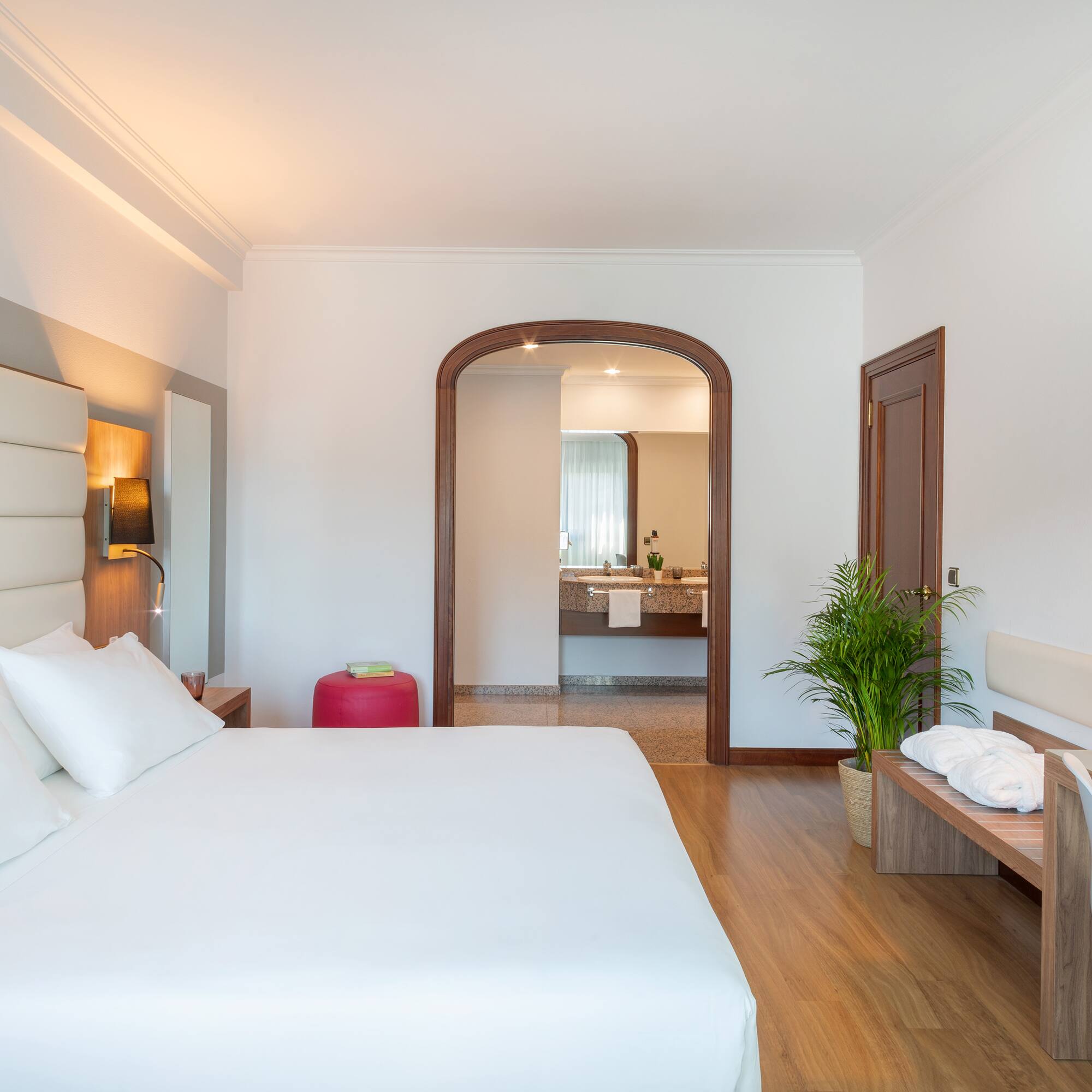 a bedroom with a bed and a bench