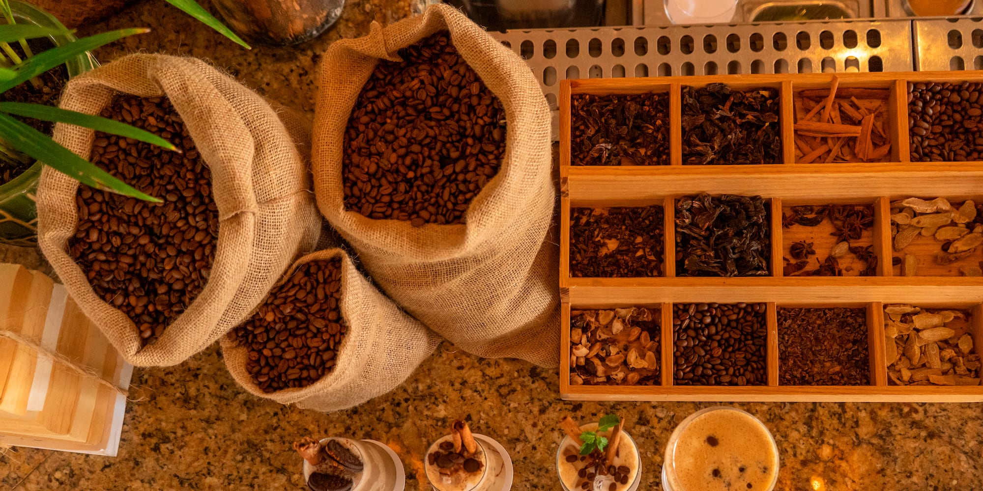 a group of bags of coffee beans and cups of coffee