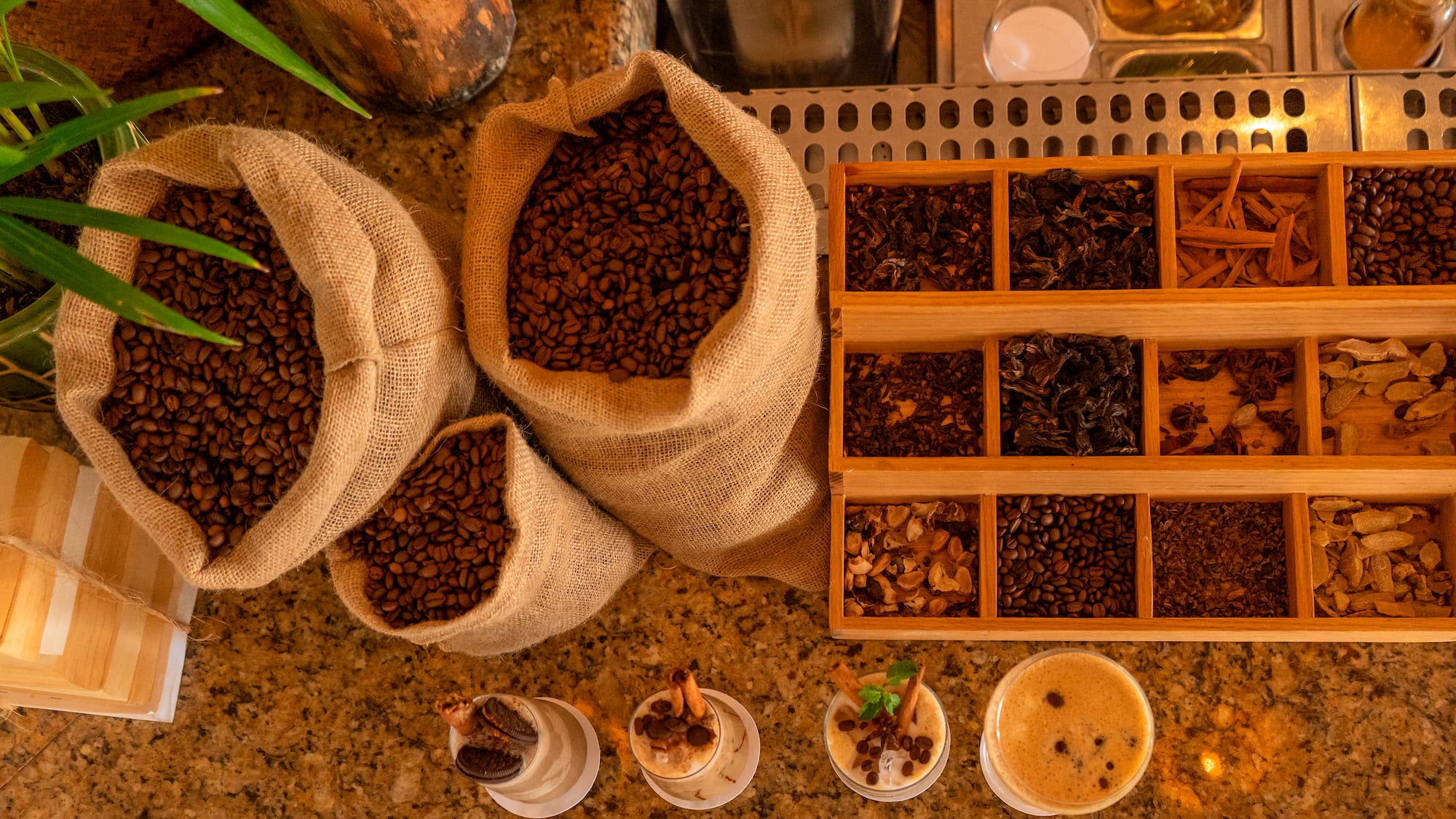 a group of bags of coffee beans and cups of coffee