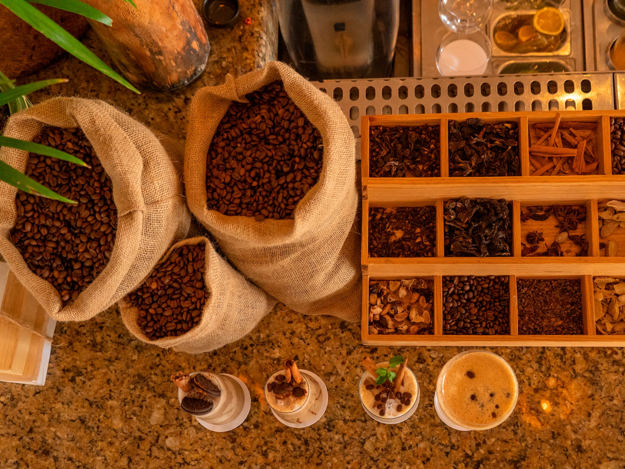 a group of bags of coffee beans and cups of coffee