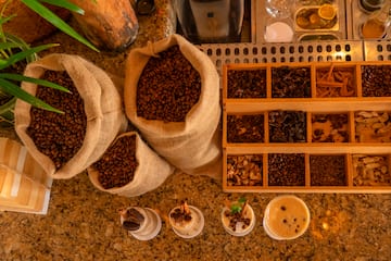 a group of bags of coffee beans and cups of coffee