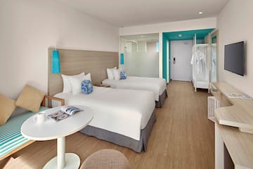 a room with two beds and a table