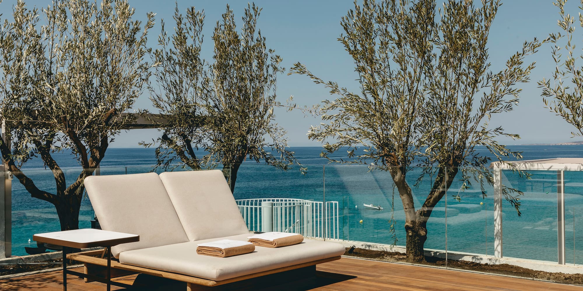 a deck with a chair and a table and chairs on it