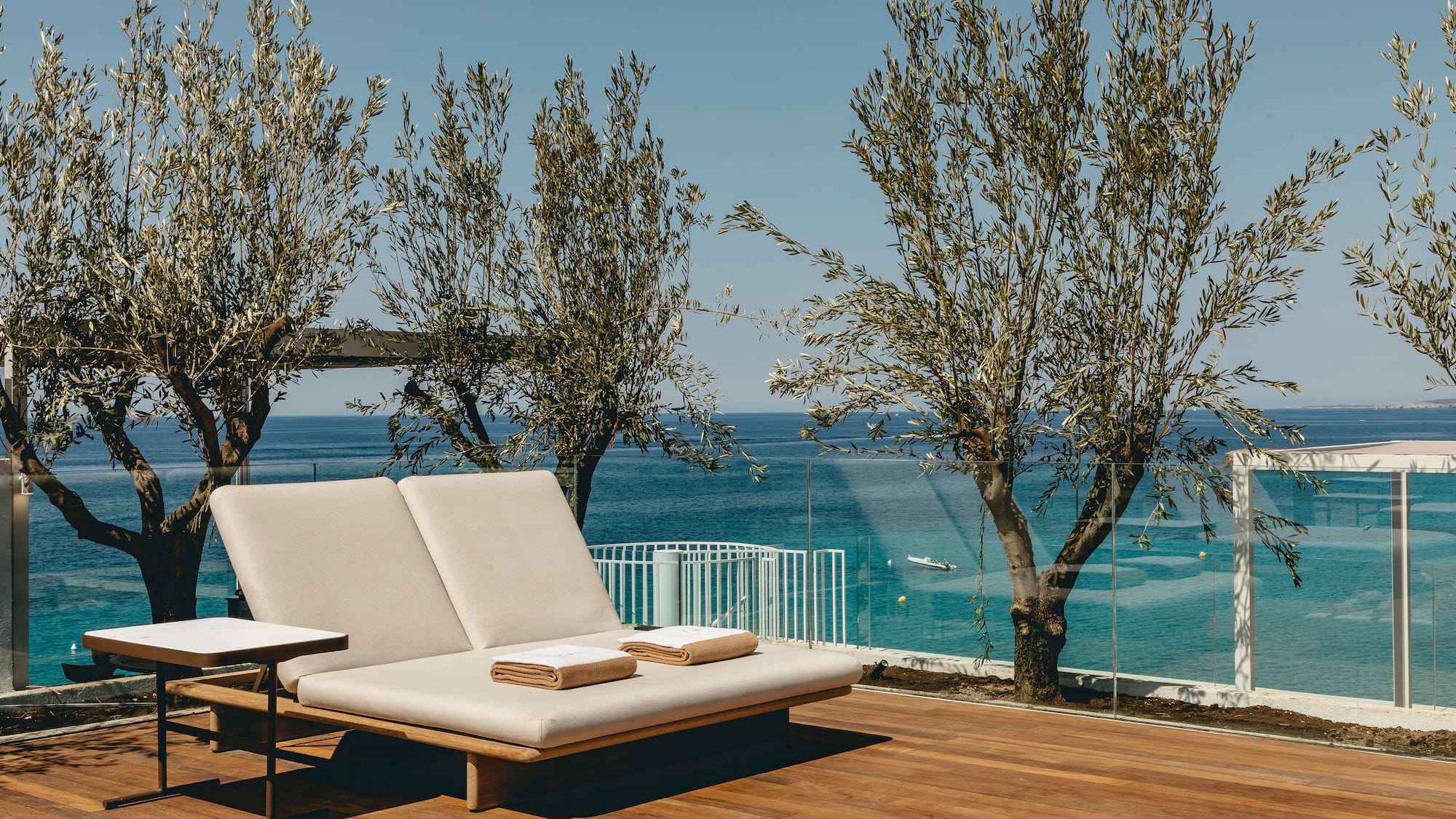 a deck with a chair and a table and chairs on it