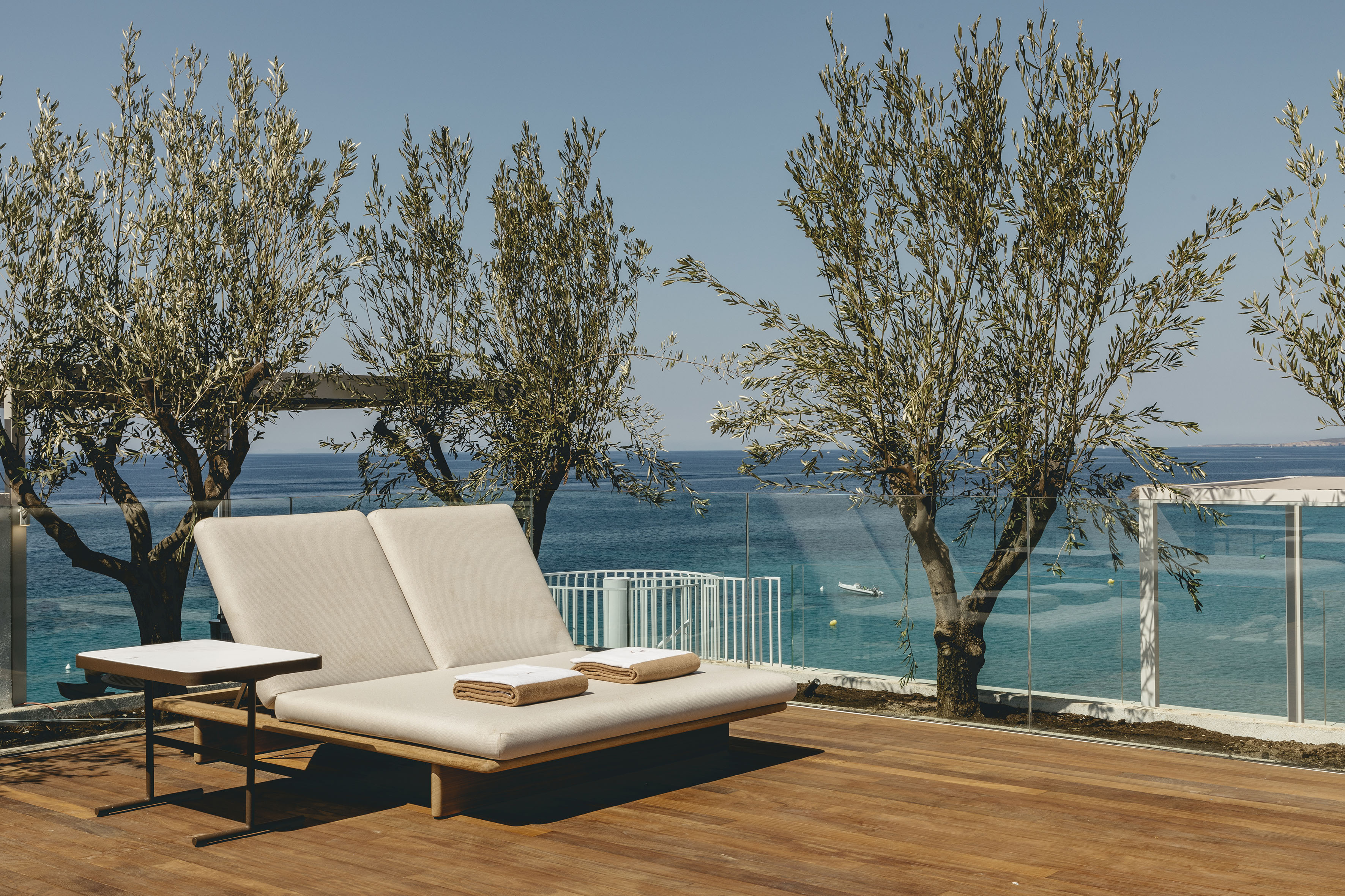 a deck with a chair and a table and chairs on it