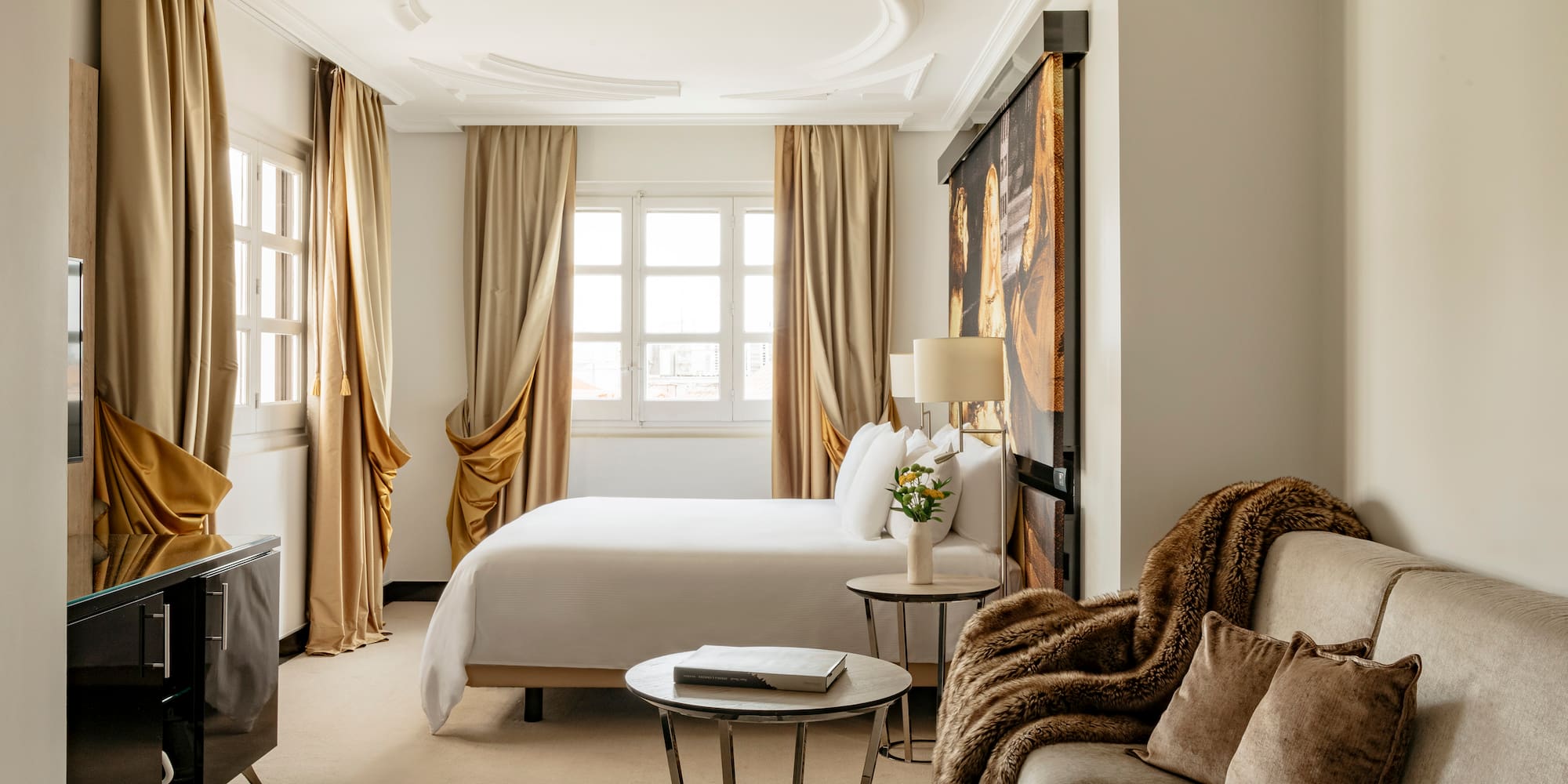 a room with a bed and couches