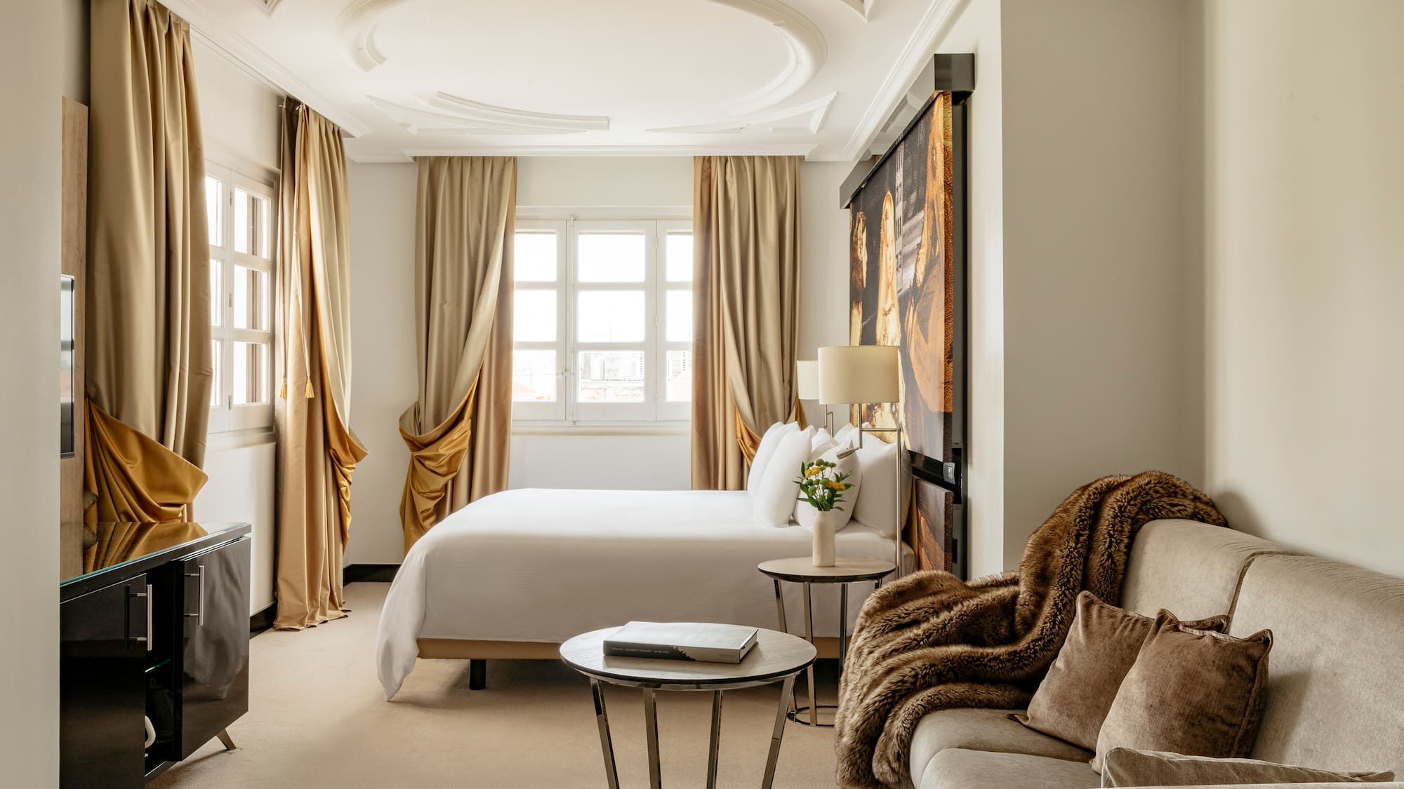 a room with a bed and couches