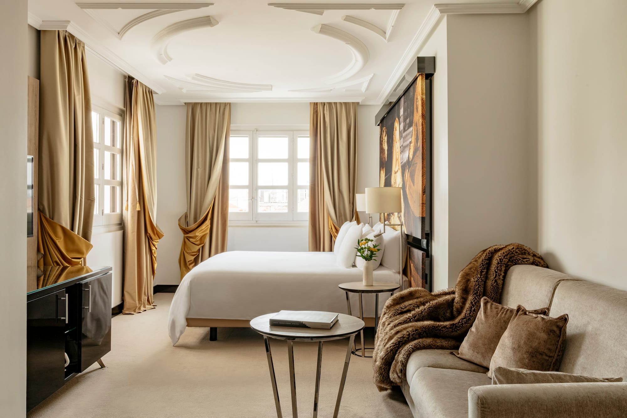 a room with a bed and couches