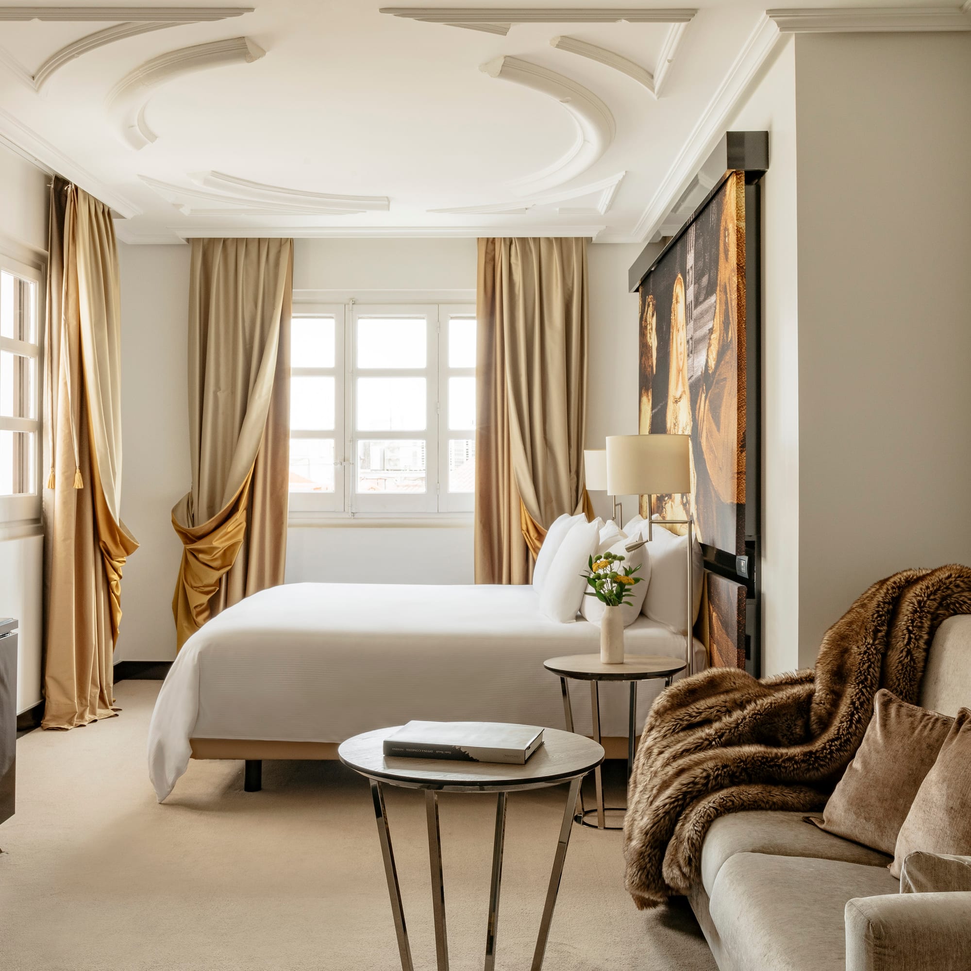 a room with a bed and couches