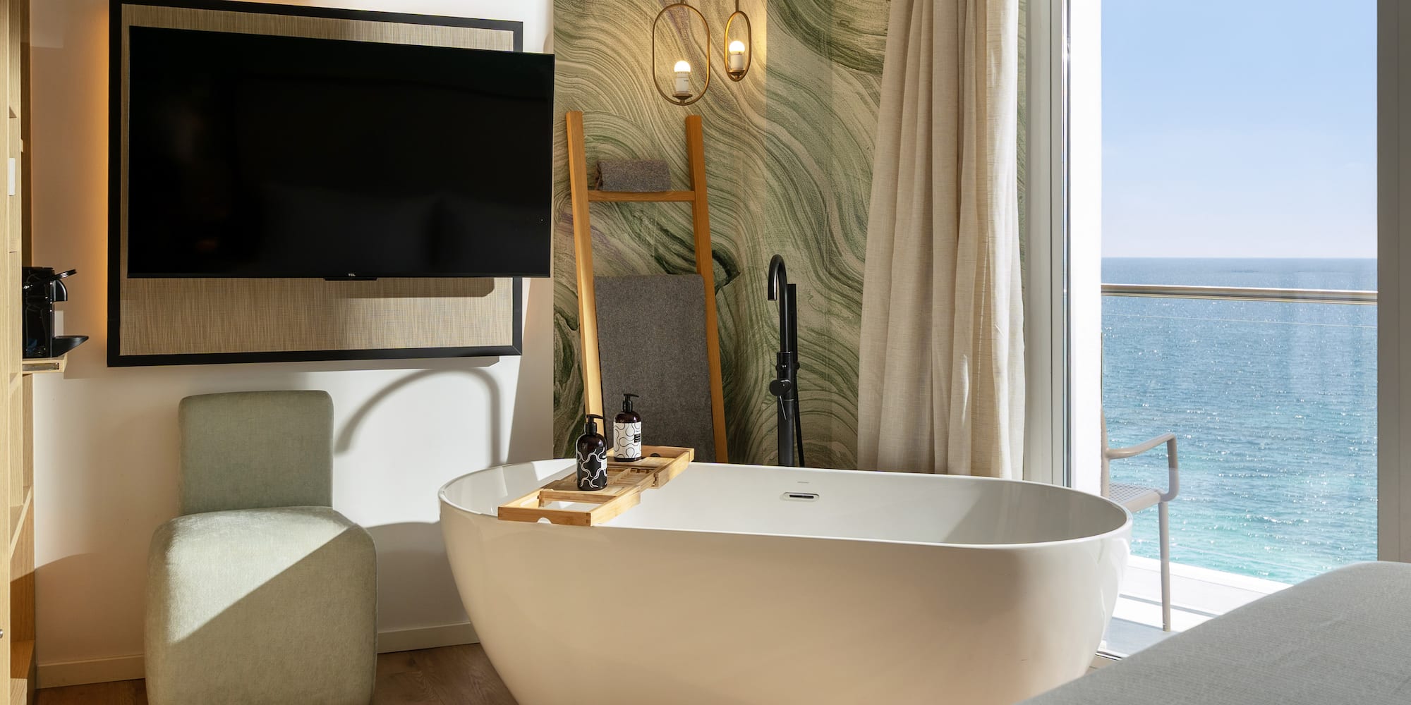 a bathroom with a tub and a television