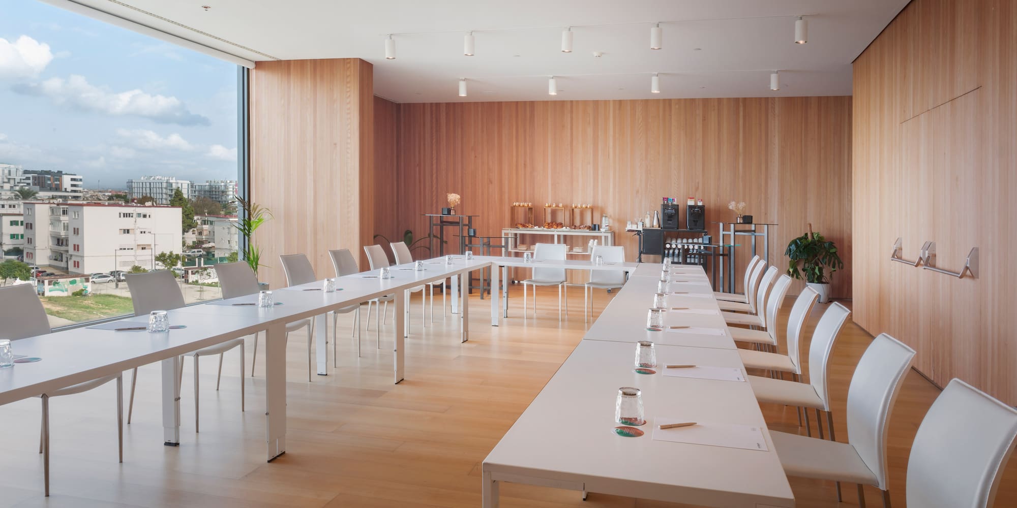 a room with white tables and chairs
