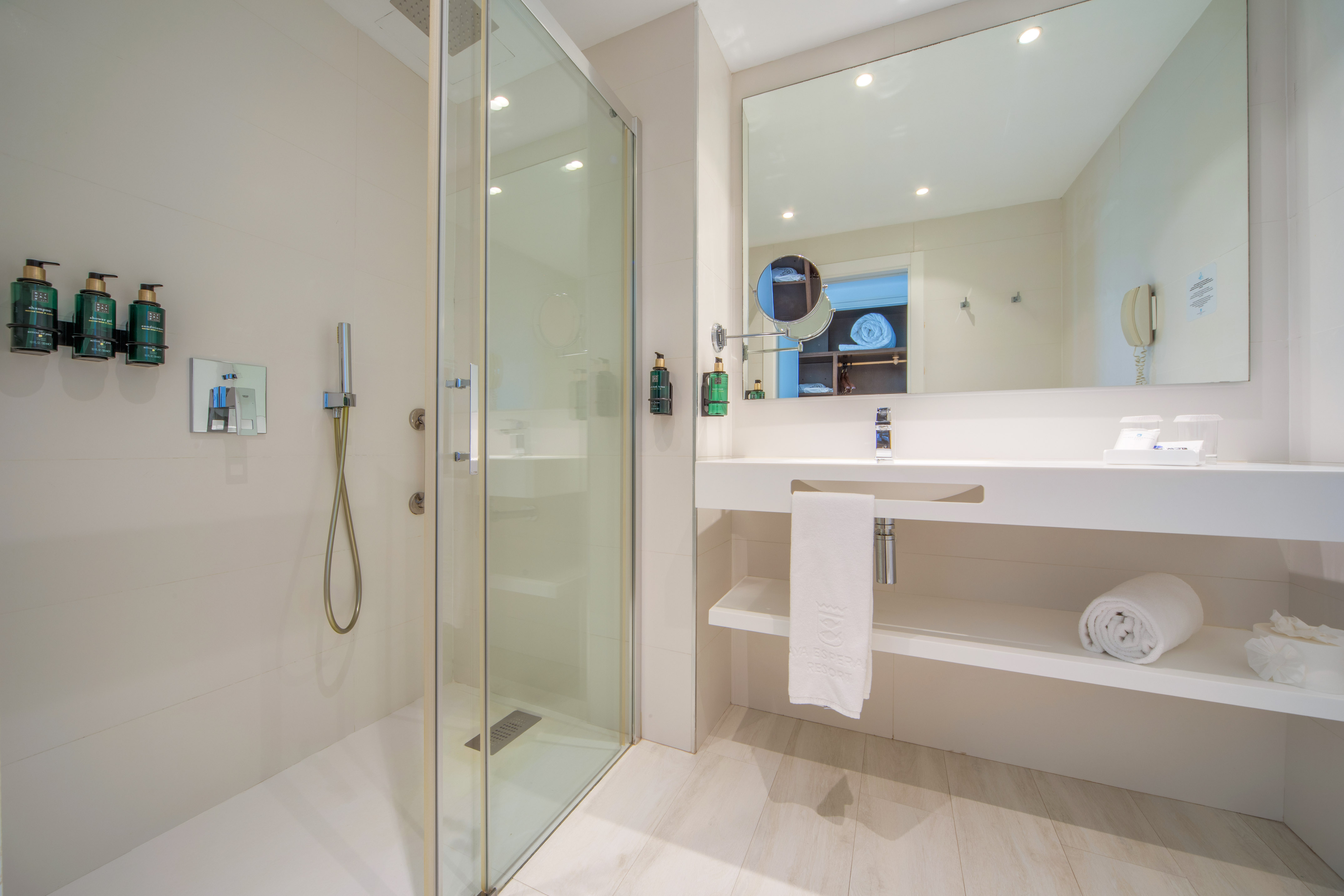 a bathroom with a shower and sink