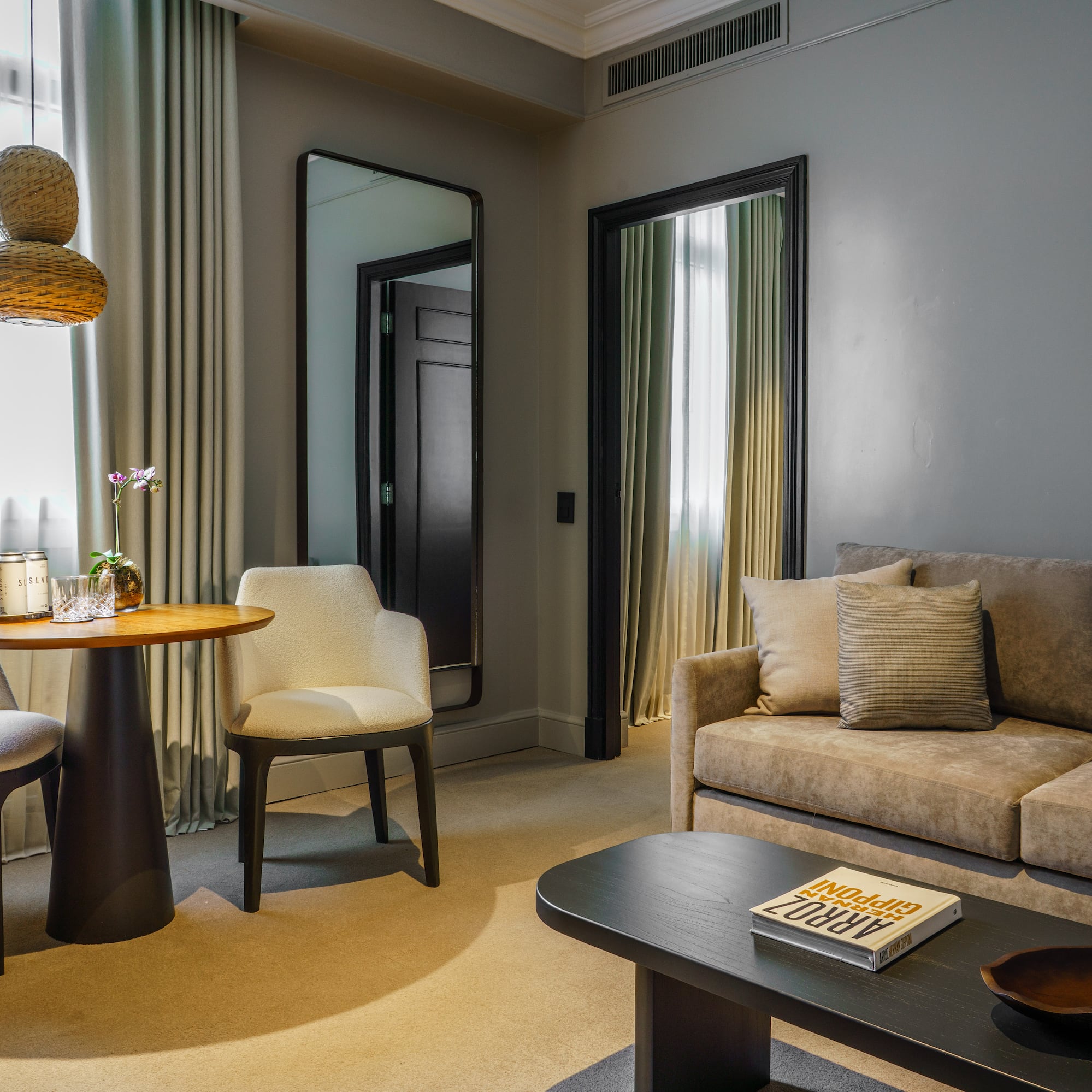 a living room with a table and chairs