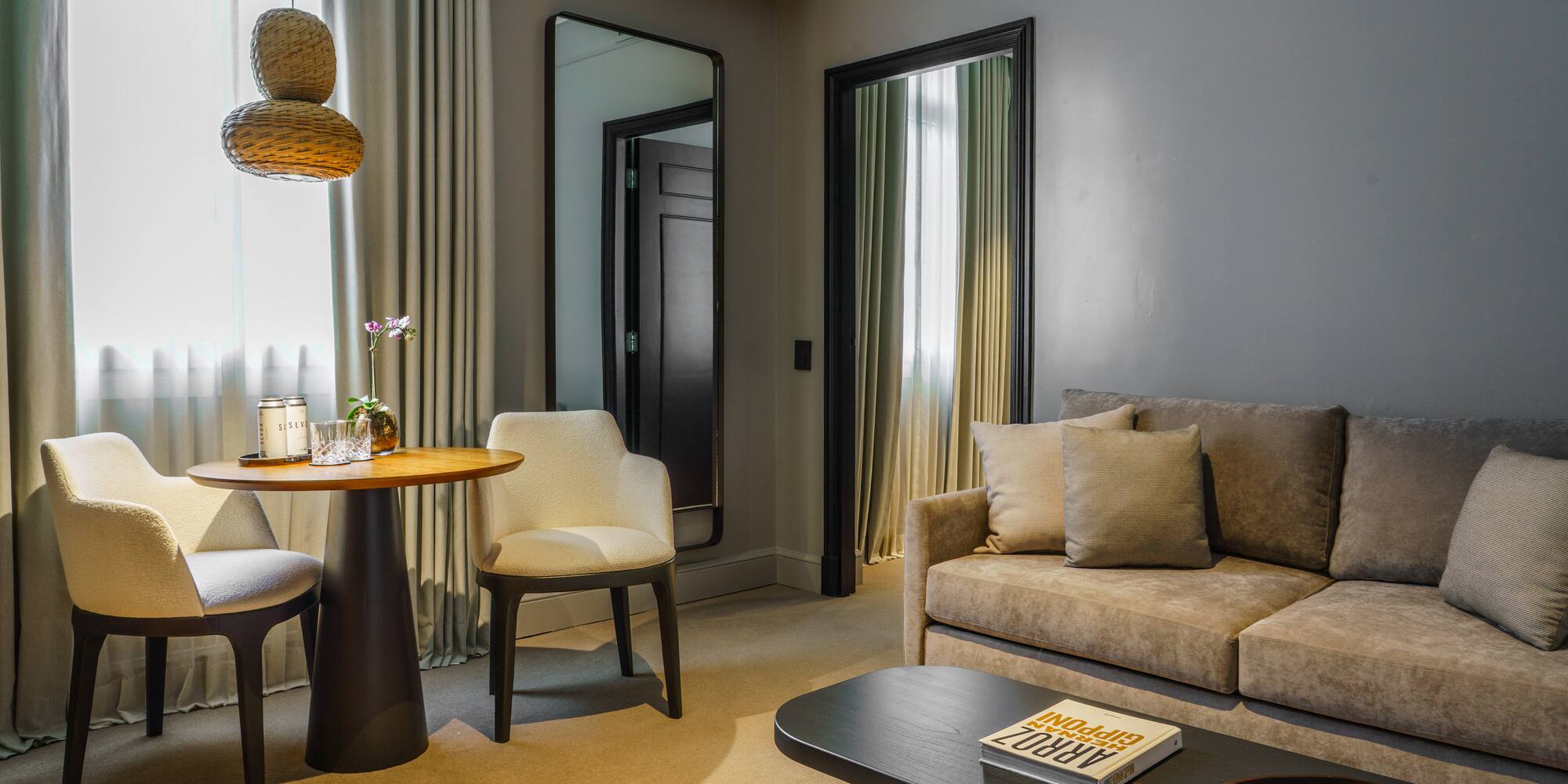 a living room with a table and chairs