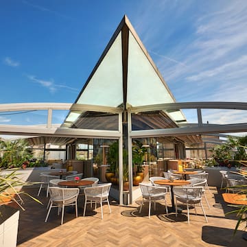 a patio with tables and chairs