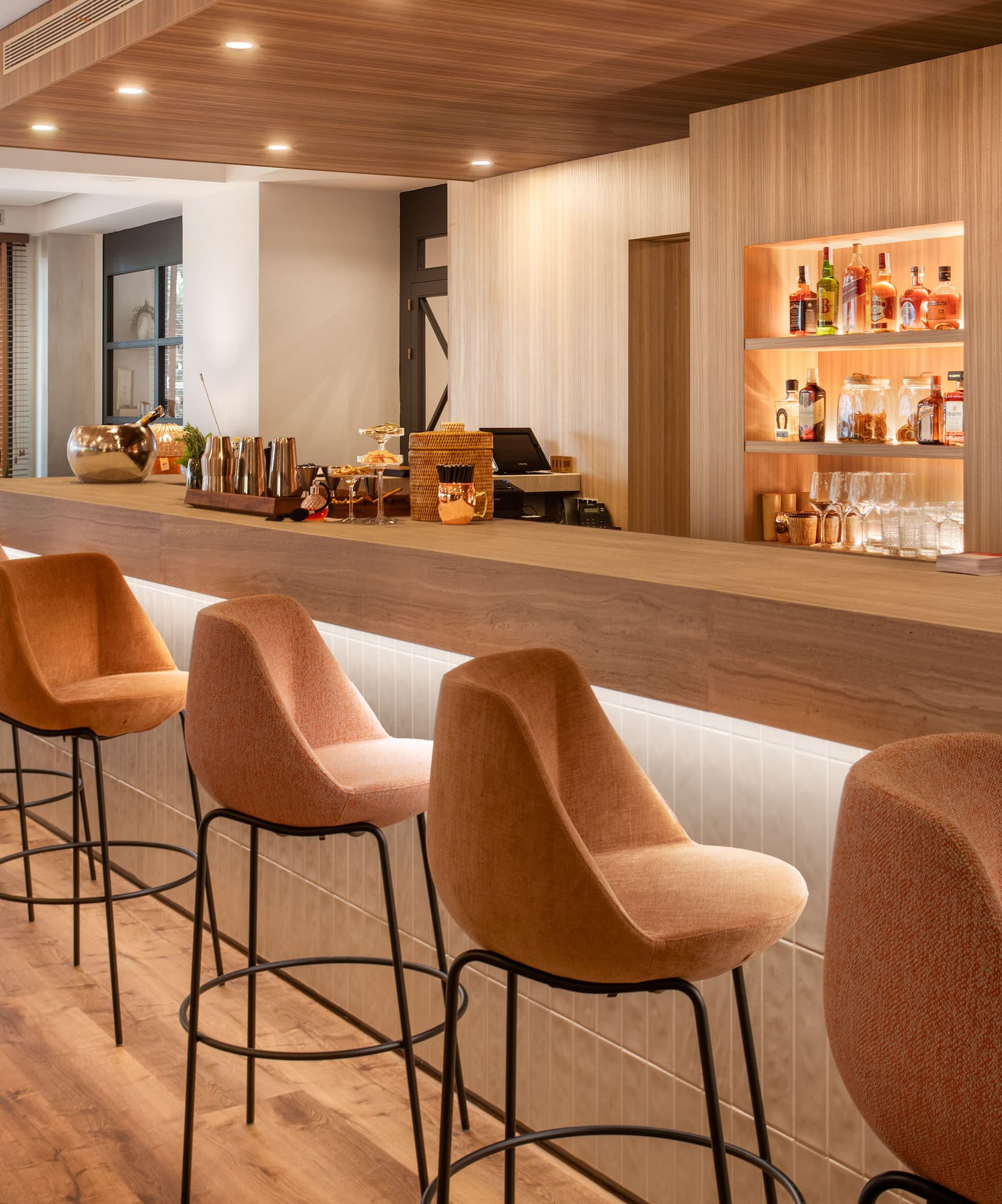 a bar with chairs and a beer dispenser