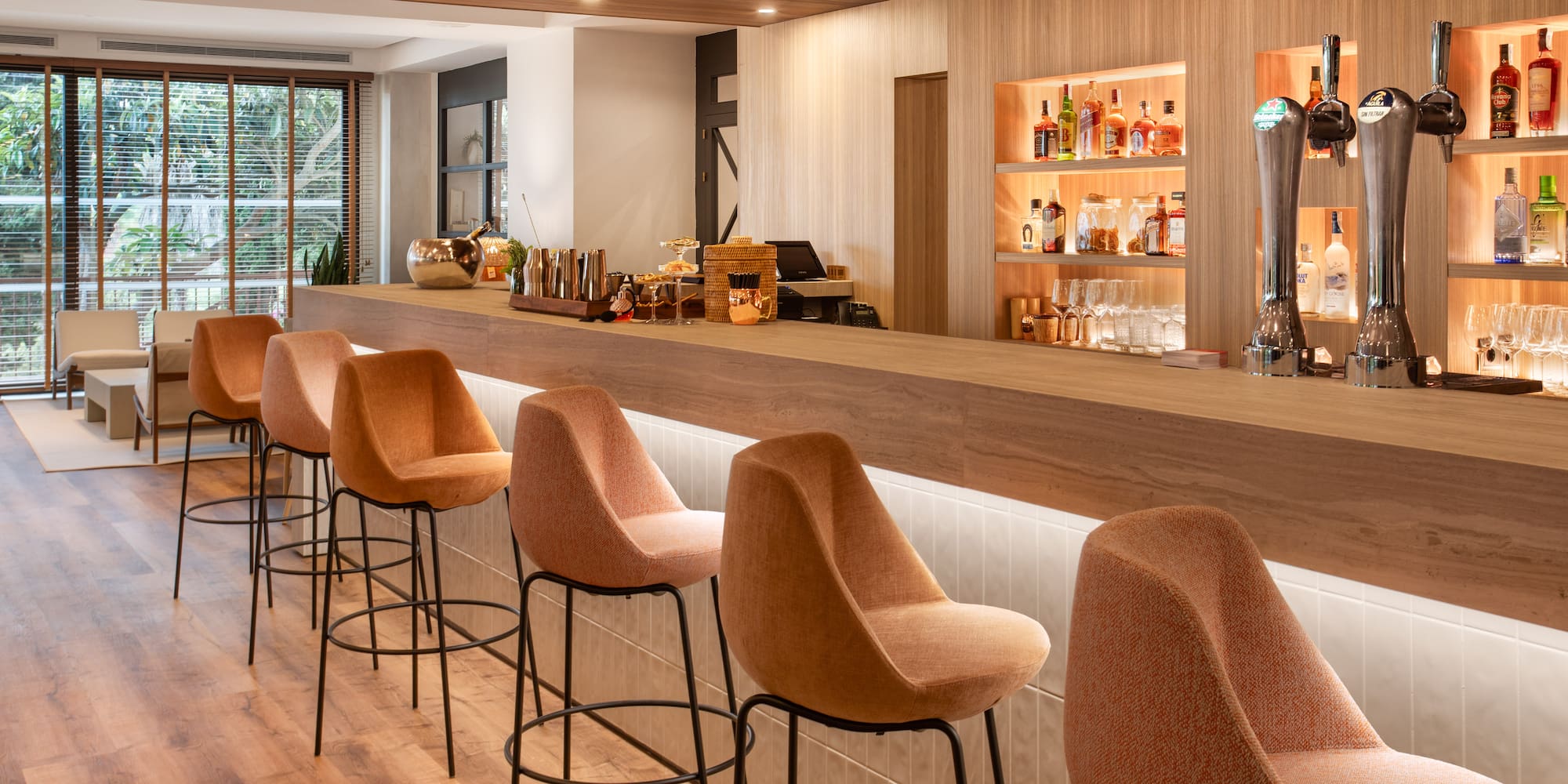 a bar with chairs and a beer dispenser