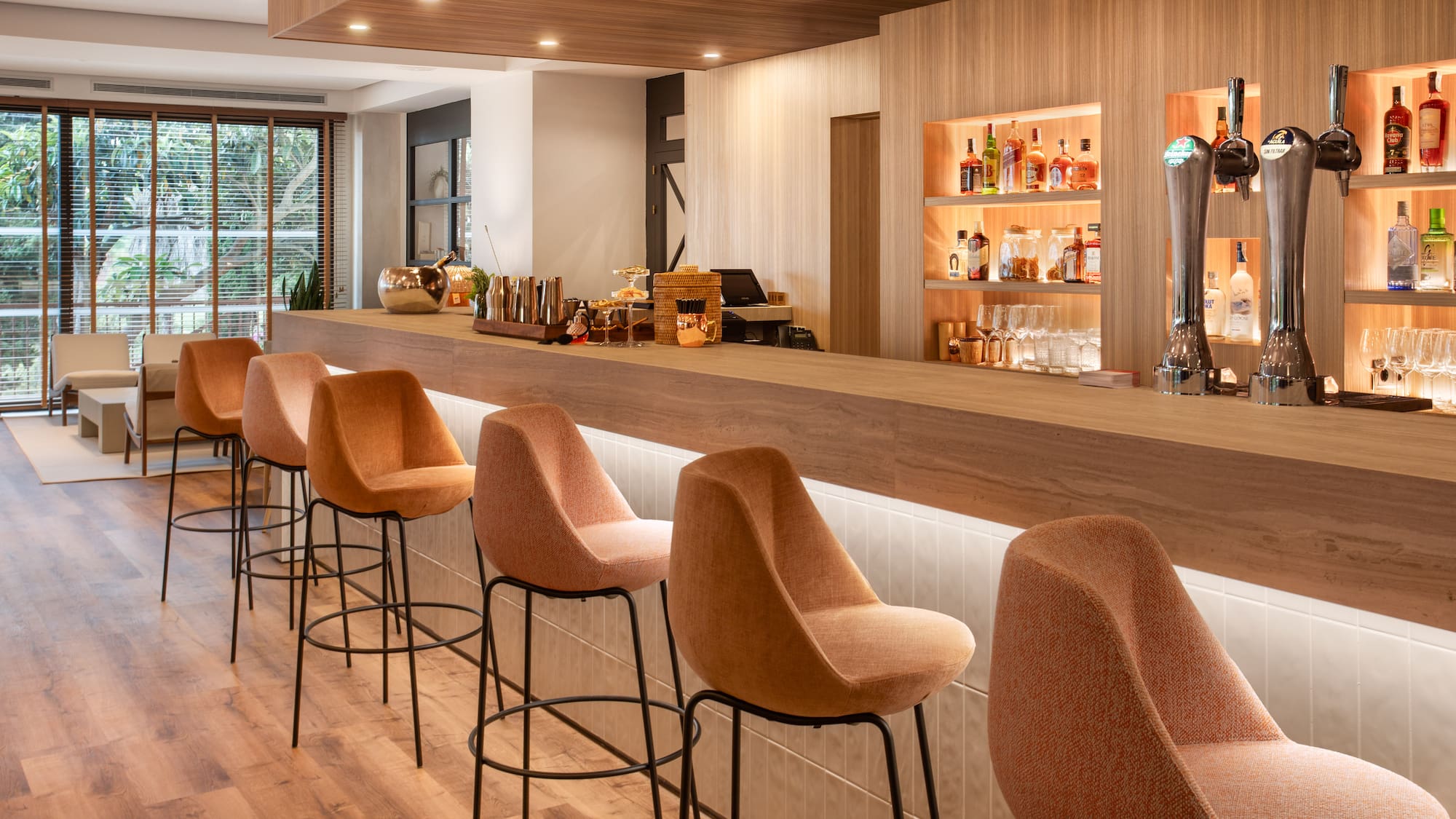 a bar with chairs and a beer dispenser