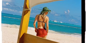 a woman in a garment on a beach