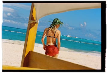 a woman in a garment on a beach
