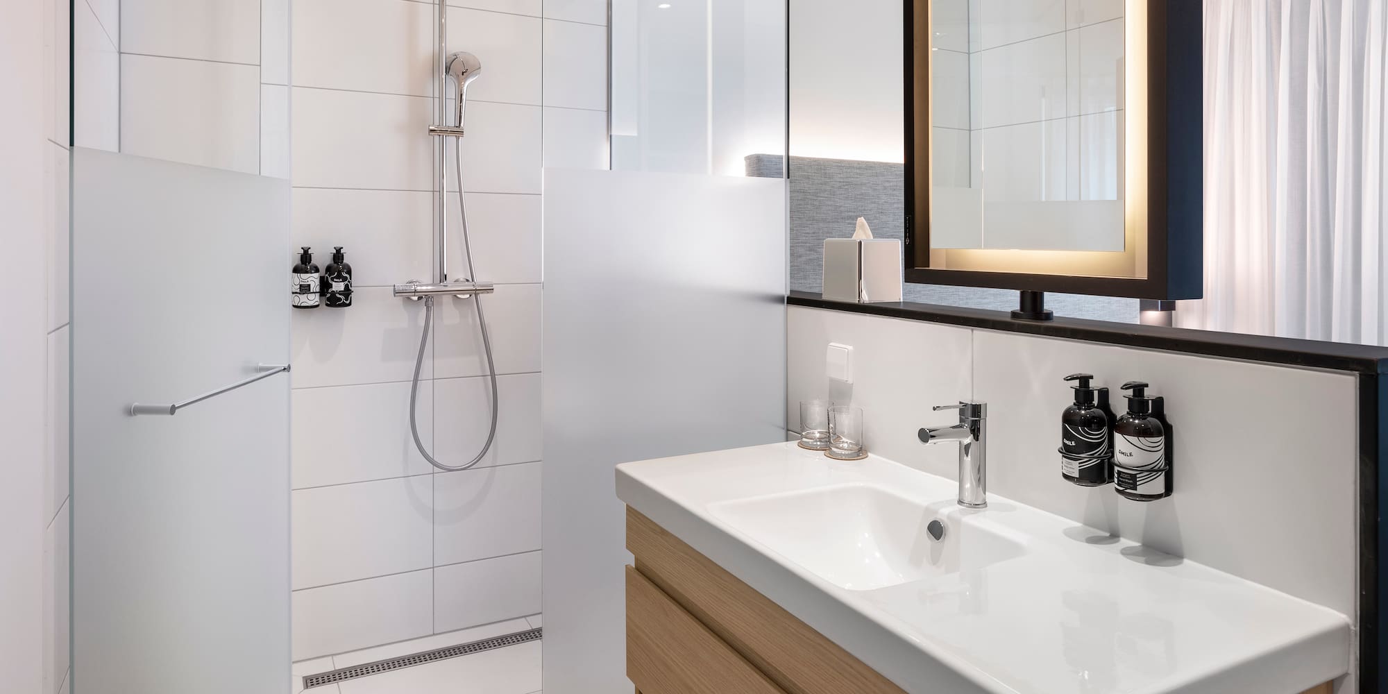 a bathroom with a shower and sink