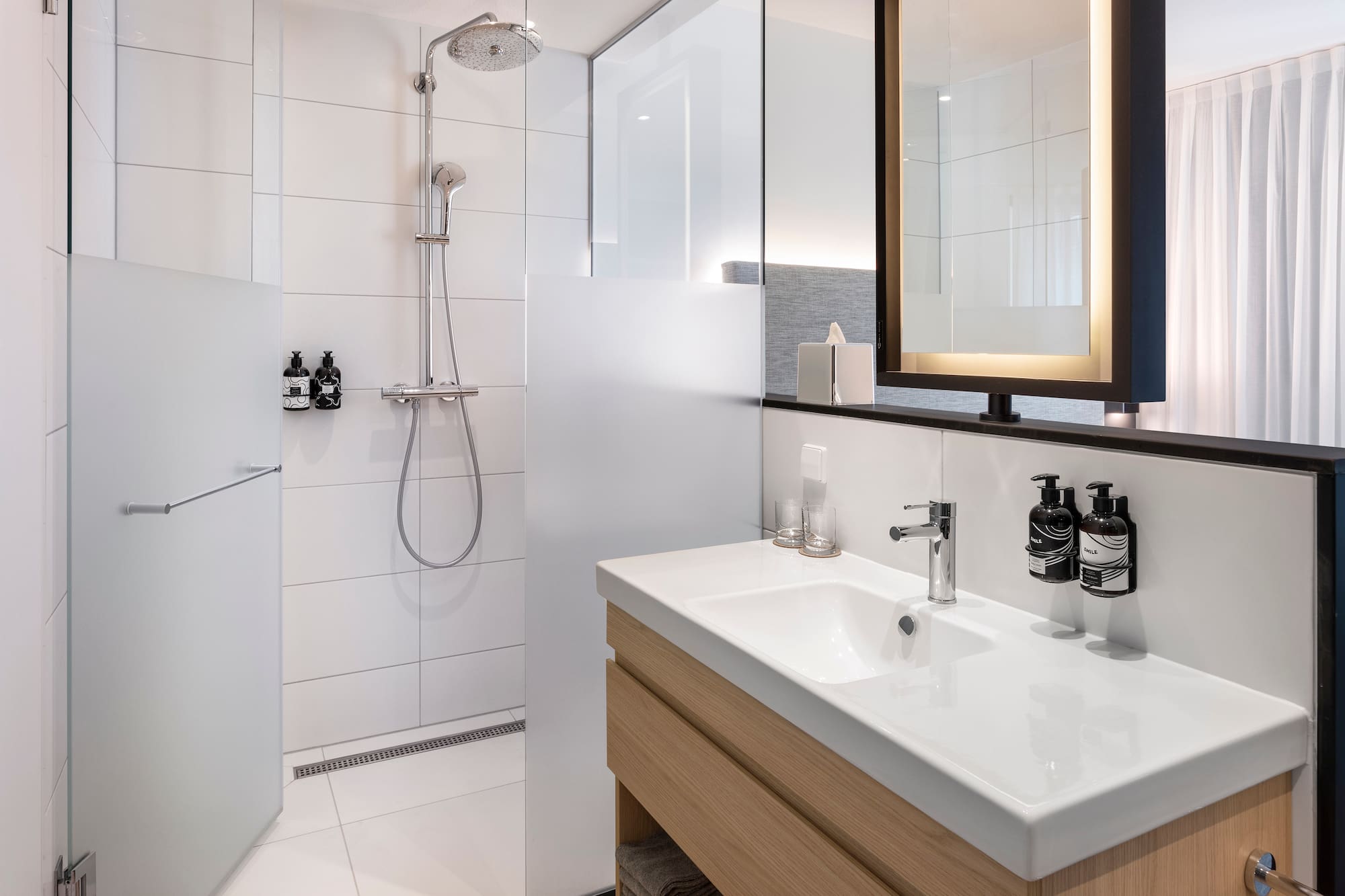 a bathroom with a shower and sink