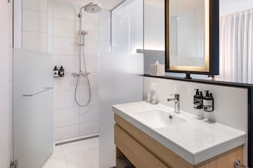 a bathroom with a shower and sink