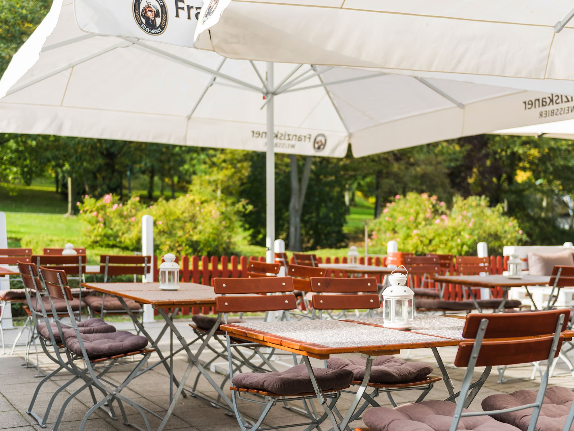 tables and chairs under umbrellas