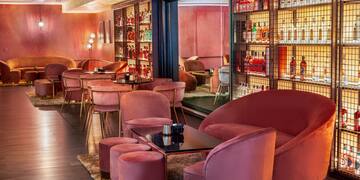 a room with pink chairs and tables